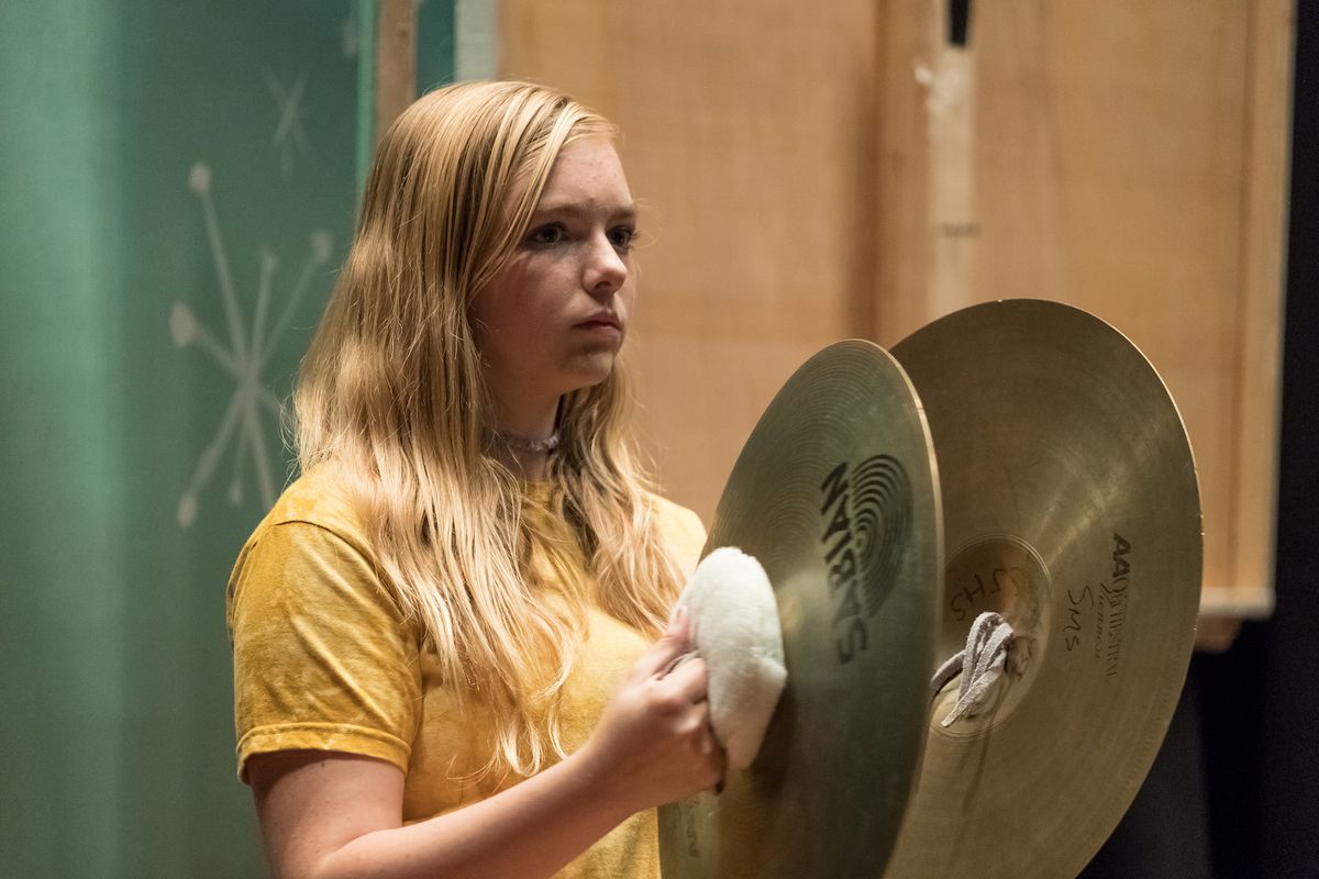 a blonde teenage girl holding two cymbals in Eighth Grade