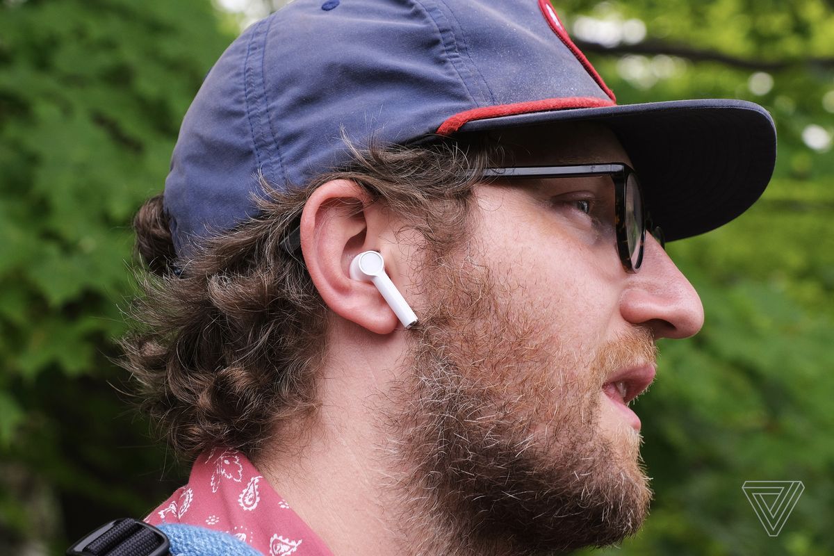 A person wearing the OnePlus Buds earbuds.