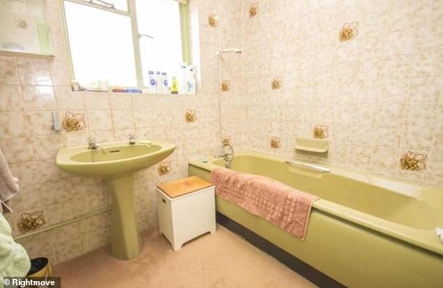 Wow! One of the bathrooms featured carpeted flooring, floral tiles and an avocado suite
