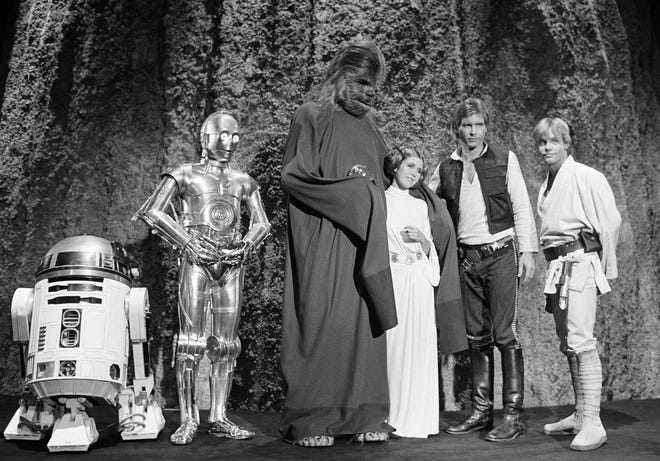Kenny Baker, Anthony Daniels, Peter Mayhew, Carrie Fisher, Harrison Ford, and Mark Hamill during the filming of the CBS-TV special "The Star Wars Holiday" in Los Angeles on Nov. 13, 1978
