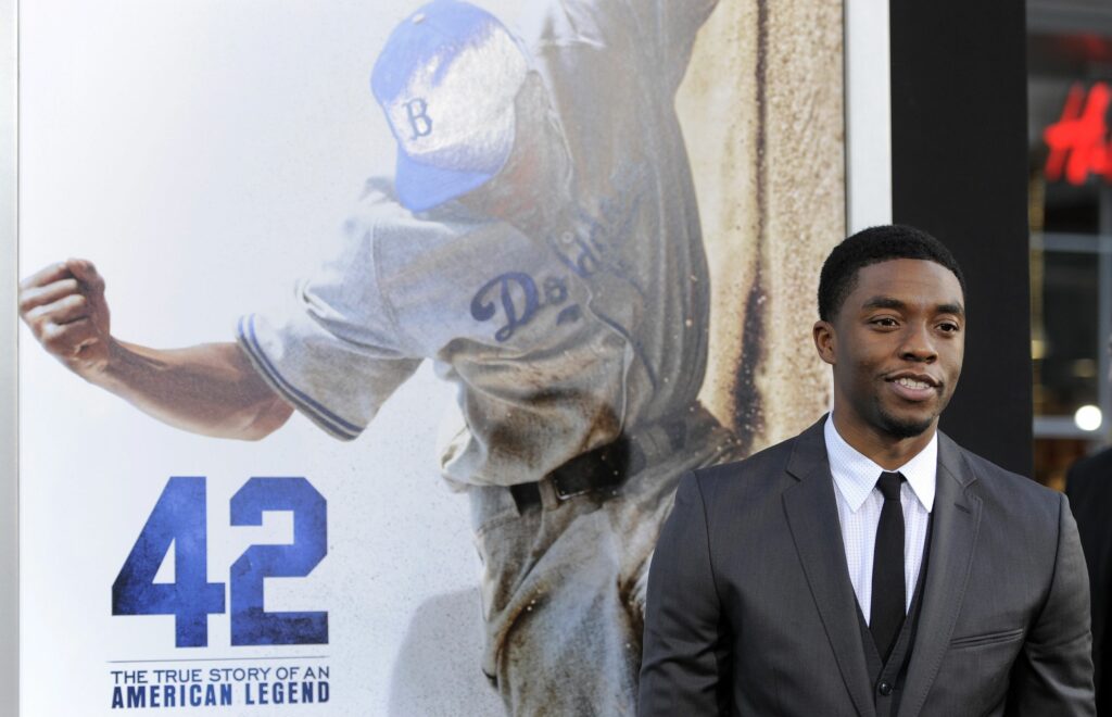 FILE - In this Tuesday, April 9, 2013 file photo, Chadwick Boseman, who plays baseball legend Jackie Robinson in "42," poses at the Los Angeles premiere of the film at the TCL Chinese Theater in Los Angeles. Actor Chadwick Boseman, who played Black icons Jackie Robinson and James Brown before finding fame as the regal Black Panther in the Marvel cinematic universe, has died of cancer. His representative says Boseman died Friday, Aug. 28, 2020 in Los Angeles after a four-year battle with colon cancer. He was 43. (Photo by Chris Pizzello/Invision/AP, File)