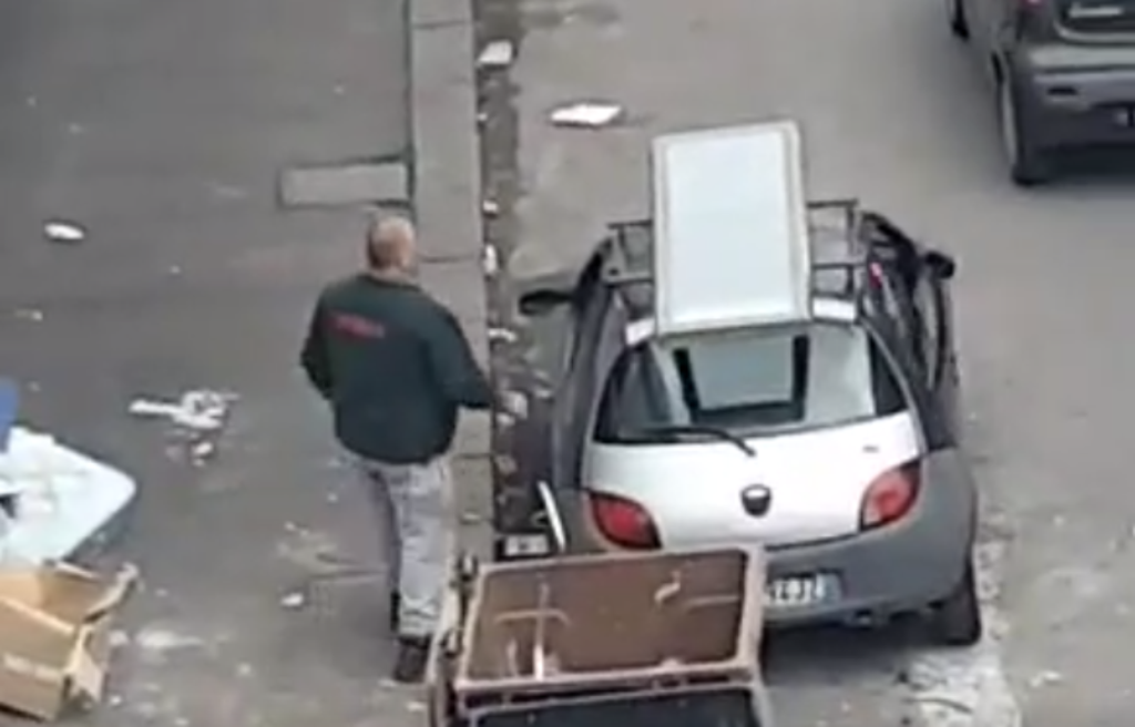 Dusty fake employee throws trash on the street