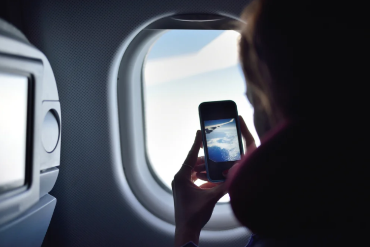 Why you should alert the crew if your cell phone falls under the seat of an airplane